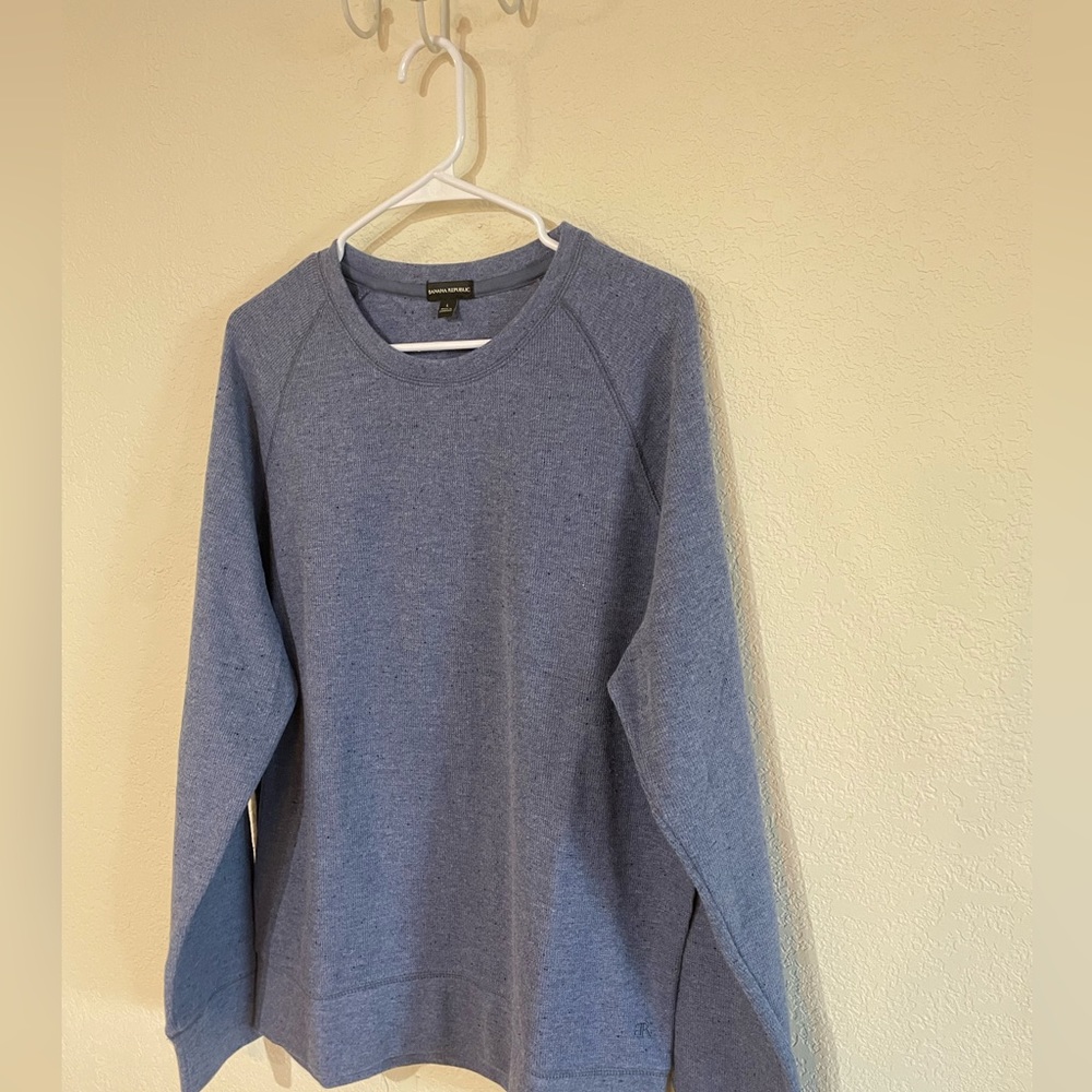 Men’s pull over style knit shirt. Light blue